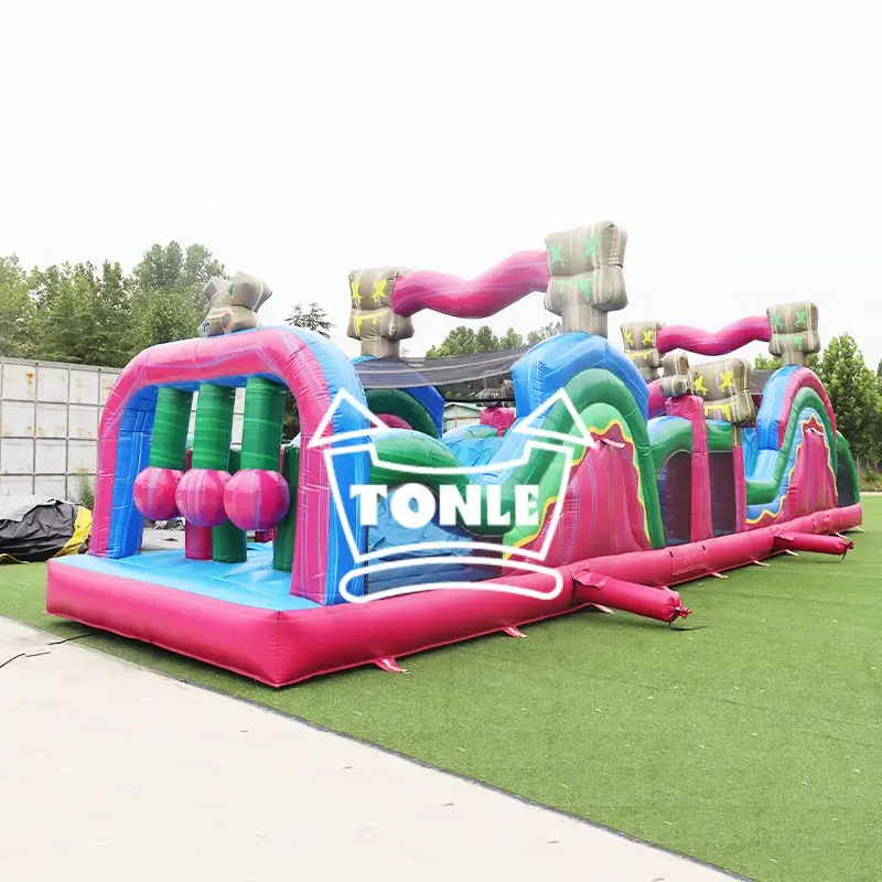 15m pink and blue pirate-themed inflatable obstacle course on green turf