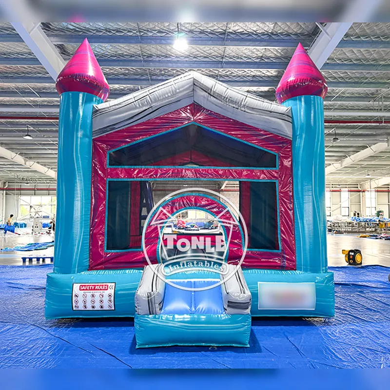 Front view of cyan and magenta Fiji Falls Castle bounce house with dual turrets