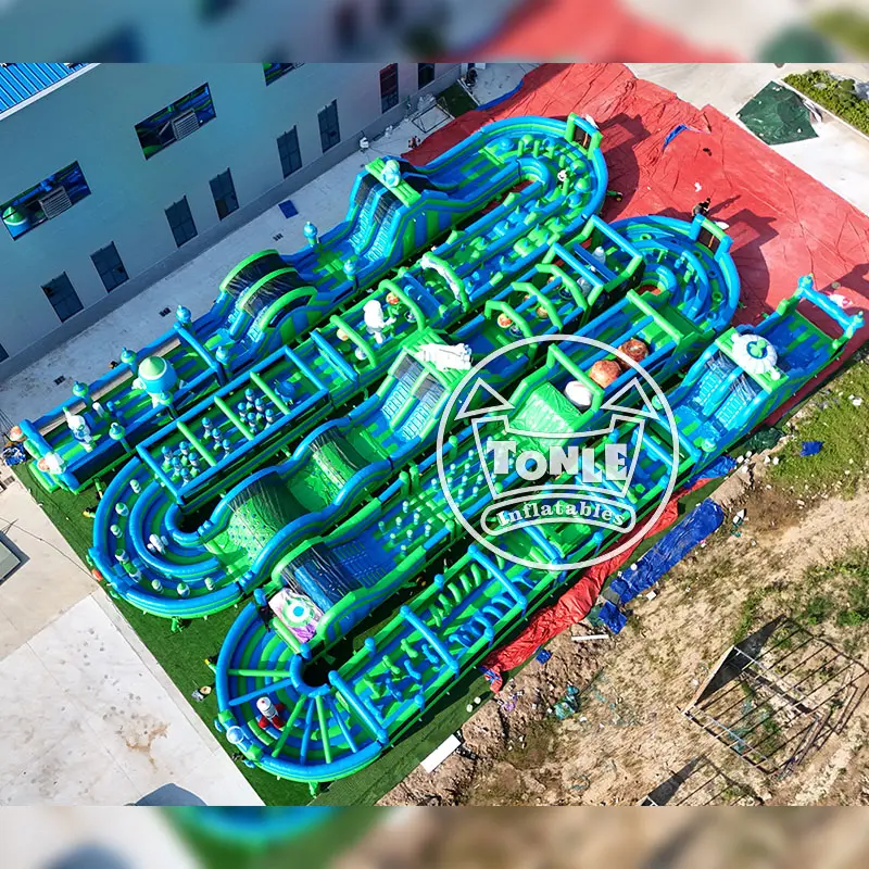 Aerial view of a massive blue and green large obstacle course with multiple lanes
