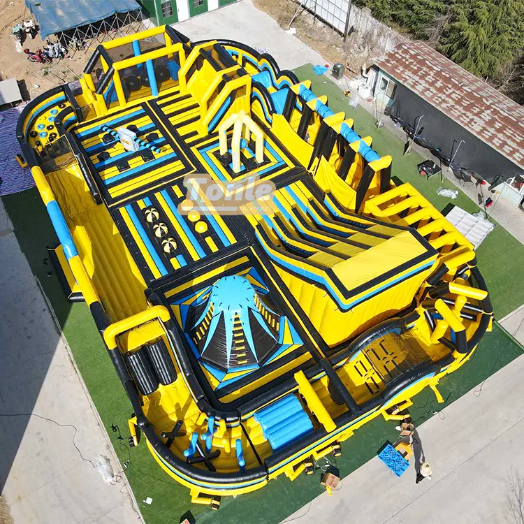 Aerial view of 30x20m yellow and black mechanical theme inflatable fun park with multiple obstacle zones