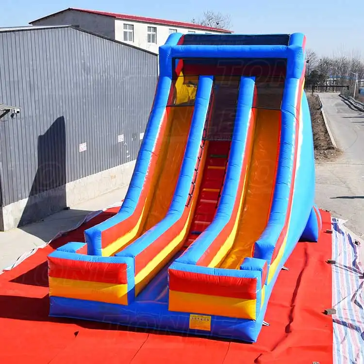 Blue and orange Cliff Hanger inflatable dry slide with dual lanes measuring 33x20x27ft