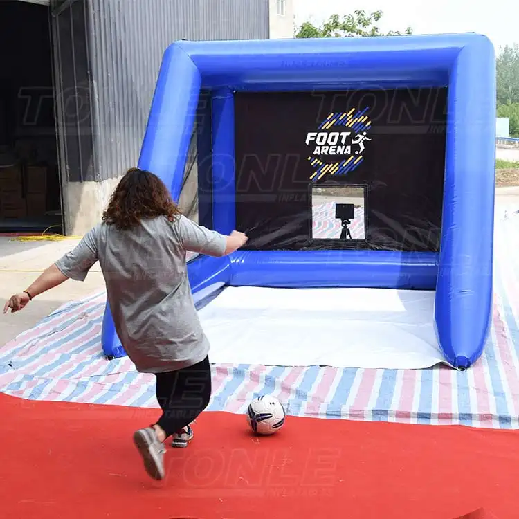 Person kicking soccer ball into blue inflatable speed test cage with black target net