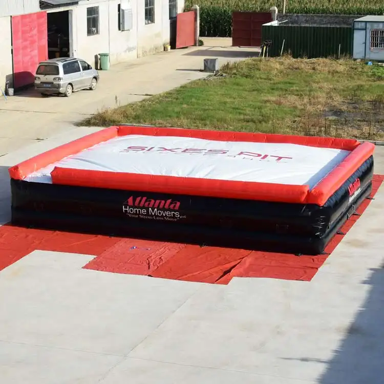 Red, black, and white 9x7.2m inflatable air bag with custom logo on white top surface