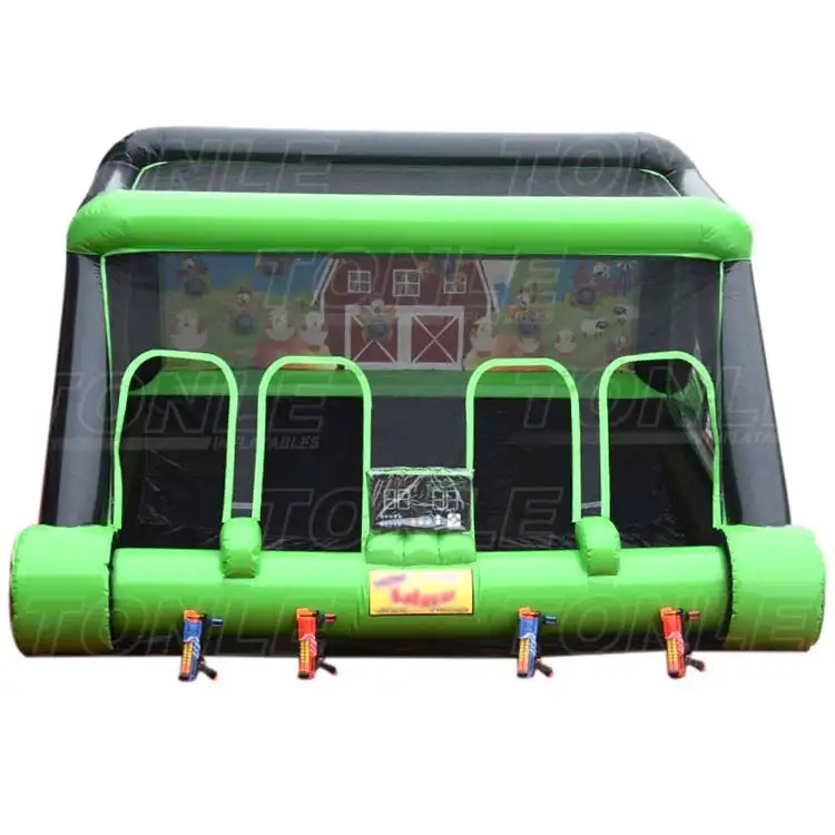 Front view of green and black inflatable shooting gallery with four lanes and farm backdrop