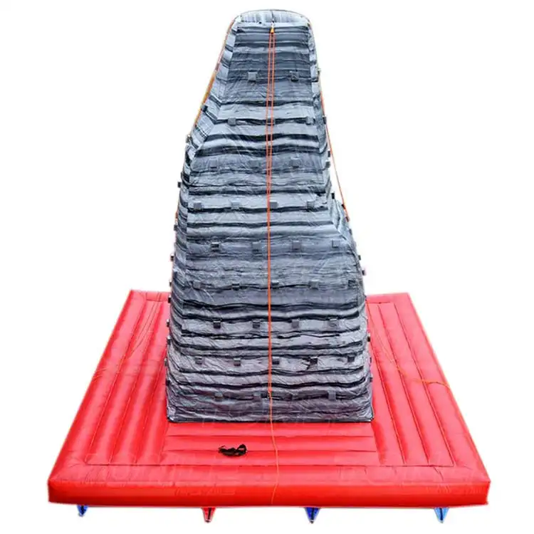Grey and red inflatable climbing wall with tapered shape and safety base