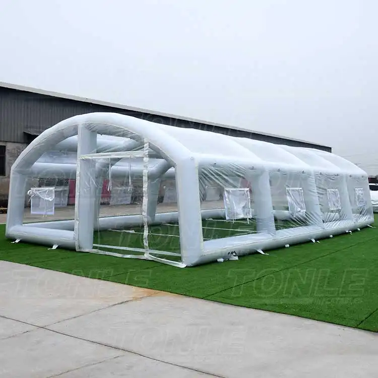 White 11.7m inflatable pool tent with transparent windows on green turf