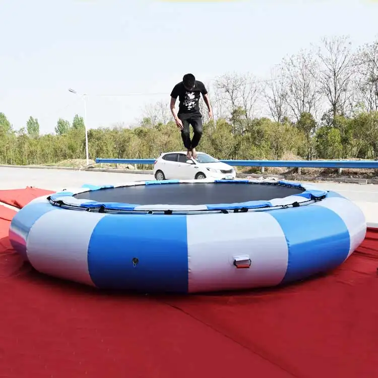 Person jumping on blue and white 3m water trampoline