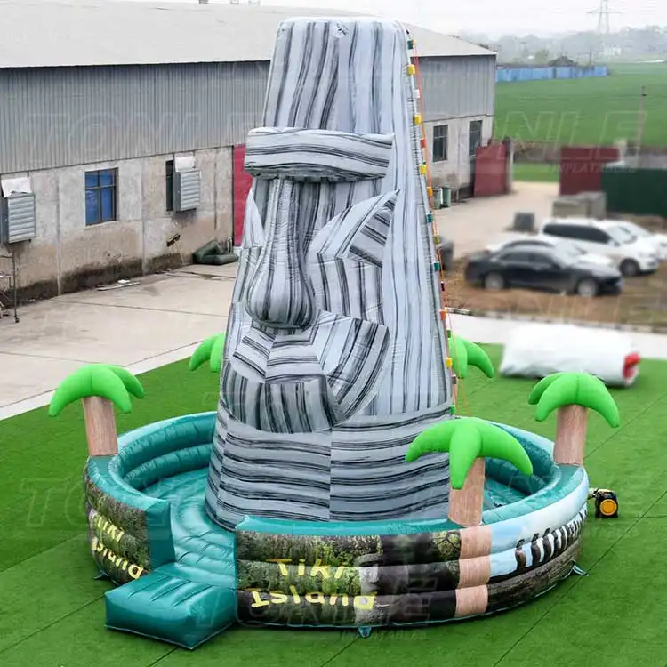 9m inflatable rock climbing game with Tiki head design and teal pool base