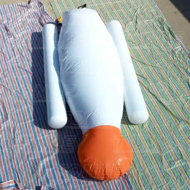 White and orange inflatable water blob deflated on striped tarp showing 10m length