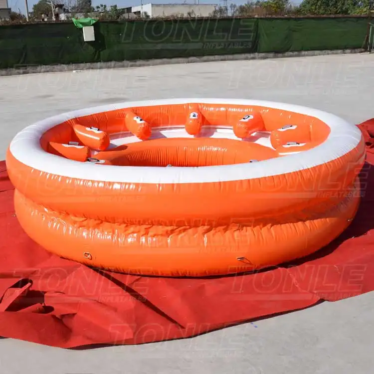 Orange and white 4m diameter inflatable floating sofa with individual backrests on ground