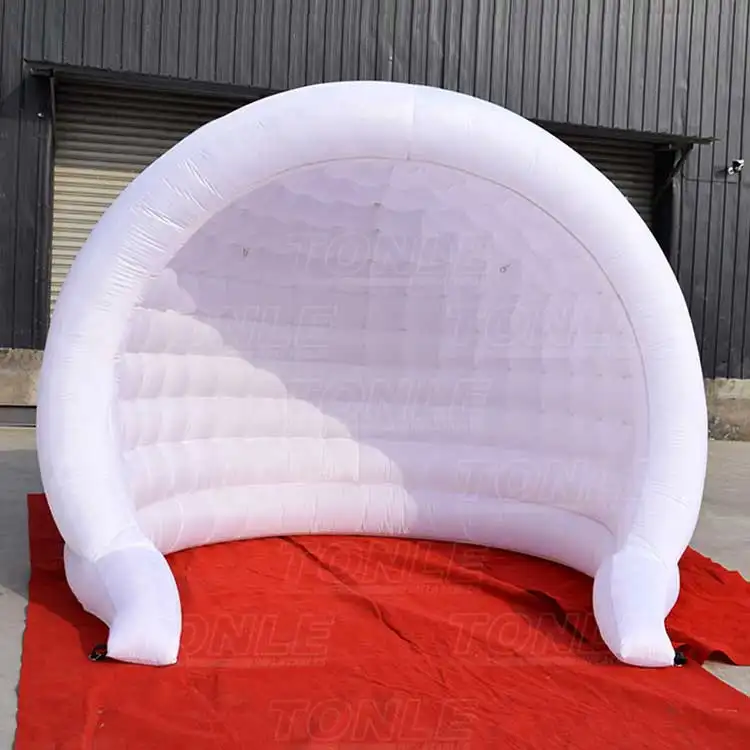 White 3x3m inflatable photo booth with curved arch and quilted back wall on red carpet