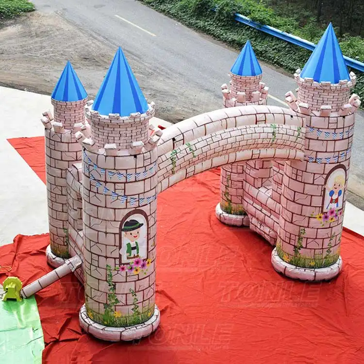 6x4x5m inflatable castle entrance arch with pink stone texture and blue turret roofs on red ground