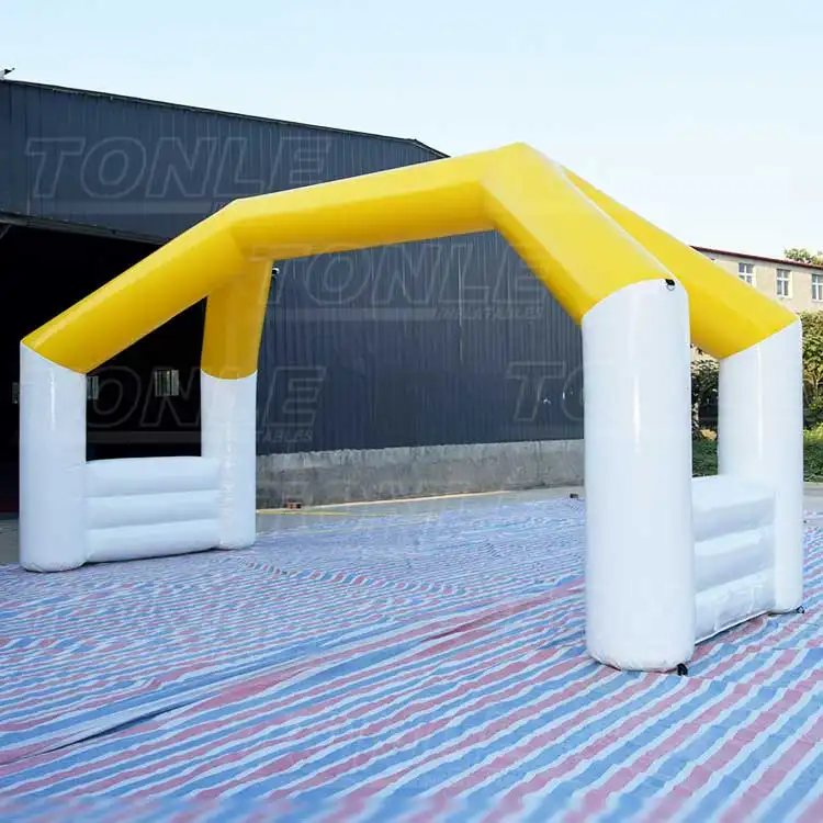 Yellow and white 7x3x4m inflatable arch on striped ground