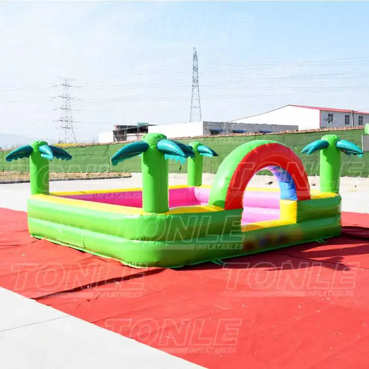 Green palm tree inflatable foam pit with rainbow arch on red ground sheet