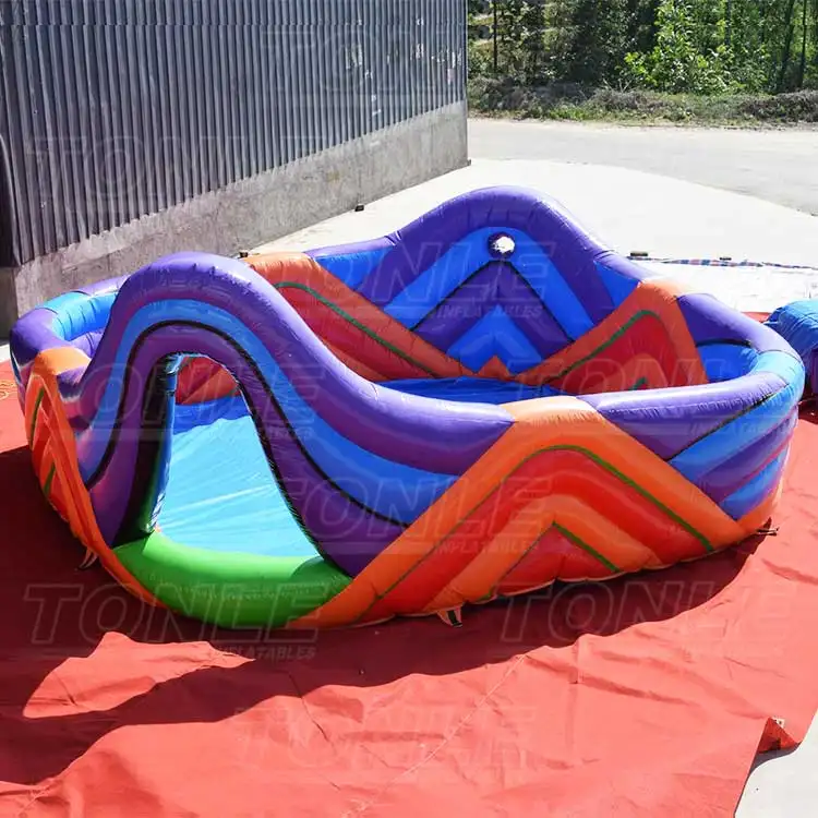 Rainbow inflatable foam pit with purple and orange chevron walls on red ground sheet