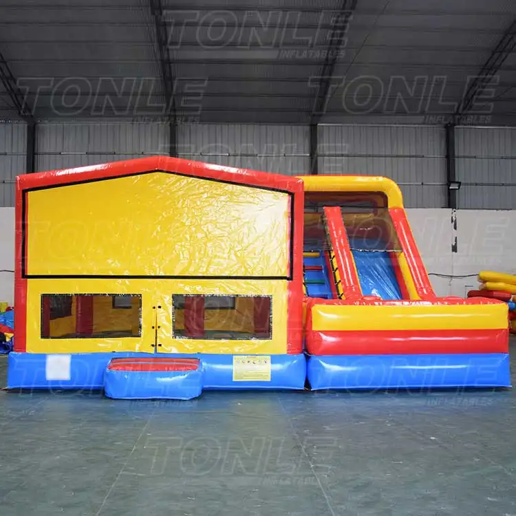 Red, yellow, and blue custom dry bounce house combo with 4x4m bouncer and 7x3.5m slide in warehouse
