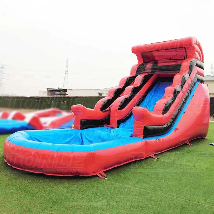 red inflatable water slide with pool — photo 1