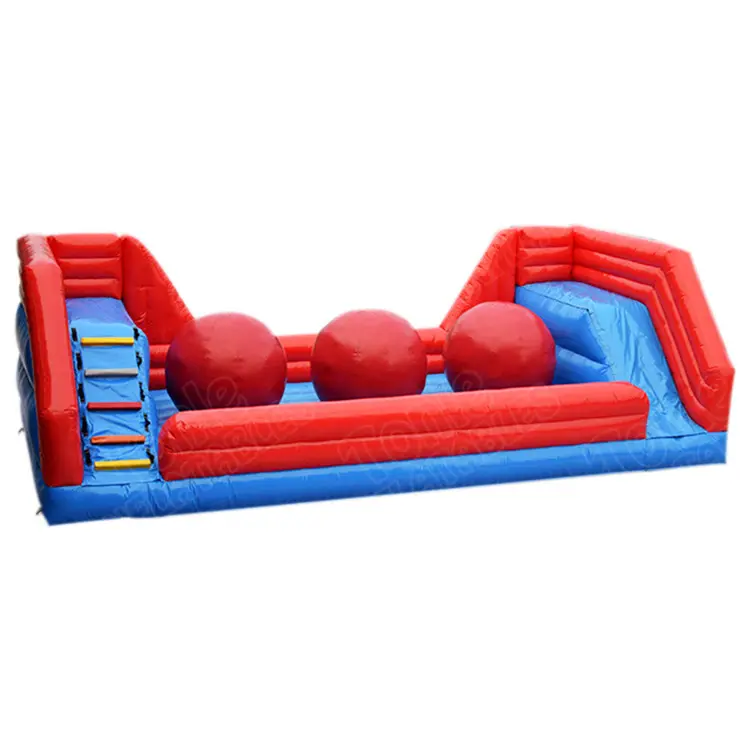 Red and blue 9m inflatable wipeout game with three large red balls and side climbing ramps