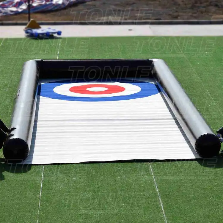 Inflatable bowling ball game with red white and blue target on white lane measuring 10x4m