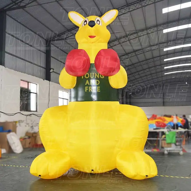 5m tall yellow inflatable kangaroo model with red boxing gloves and green torso text standing in a warehouse
