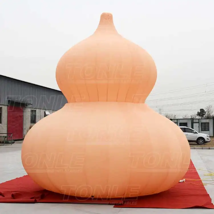 4.5m orange inflatable gourd replica standing on red carpet outdoors