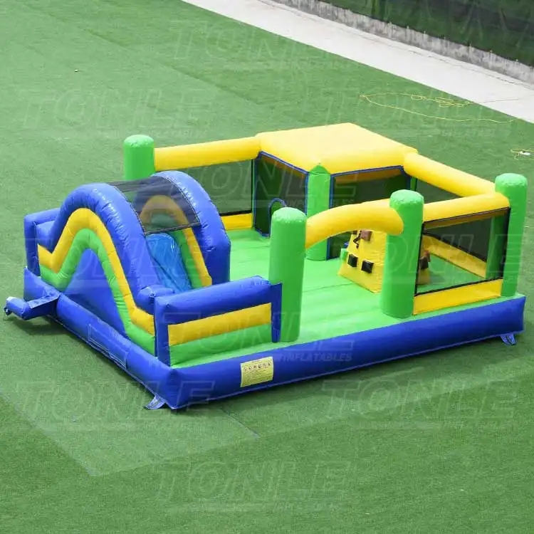 Green and blue inflatable obstacle combo with yellow accents on artificial grass