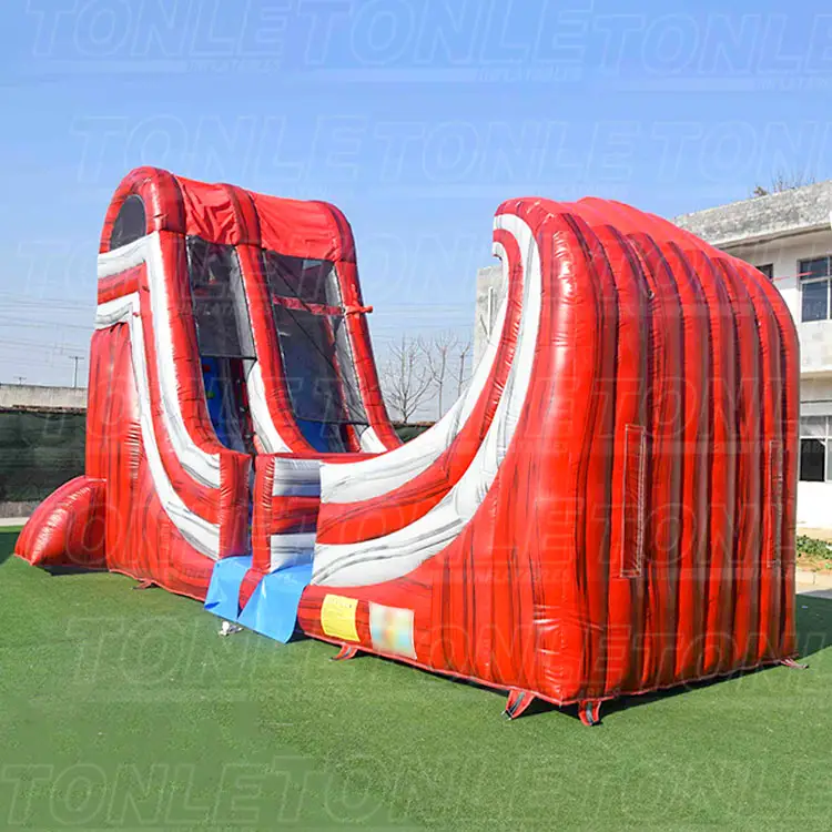 Red and white 9m inflatable dry slide on green turf