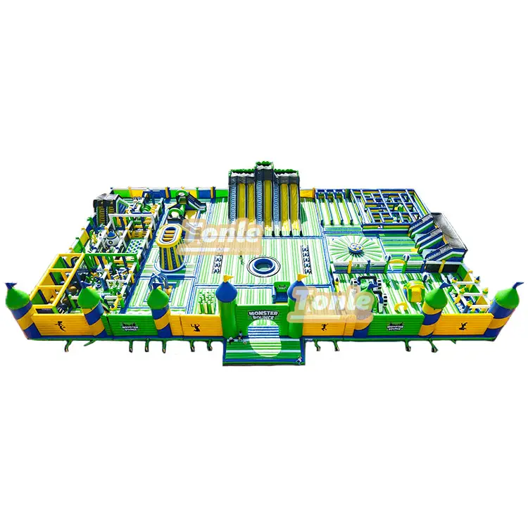 Aerial view of 60x40m green and yellow monster theme inflatable fun city with multiple obstacle zones