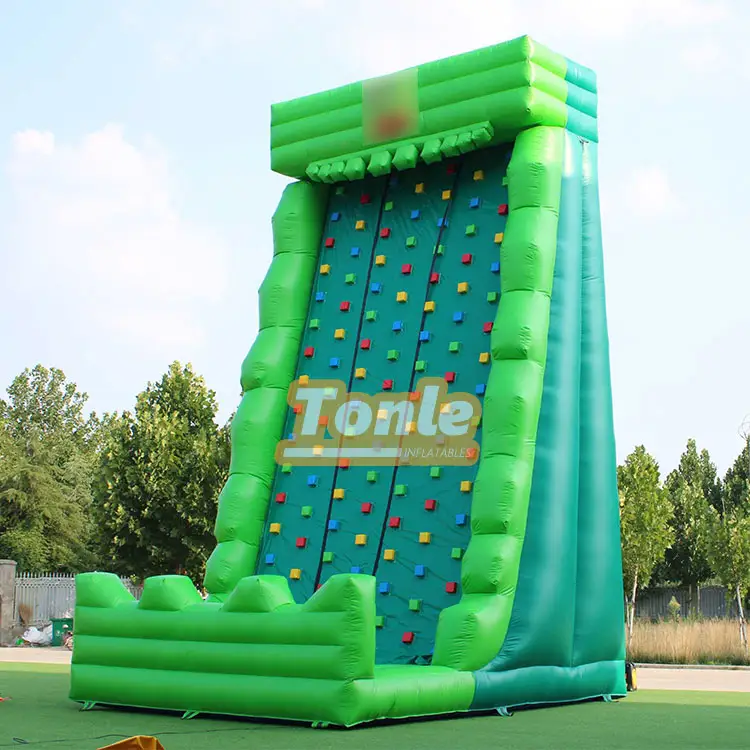 Green and teal inflatable rock climbing wall with colorful handholds measuring 5x6x10m