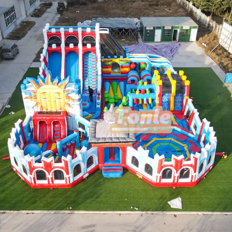 Aerial view of 15.7x21.5m Sunny Theme Park inflatable with red castle walls and sun slide