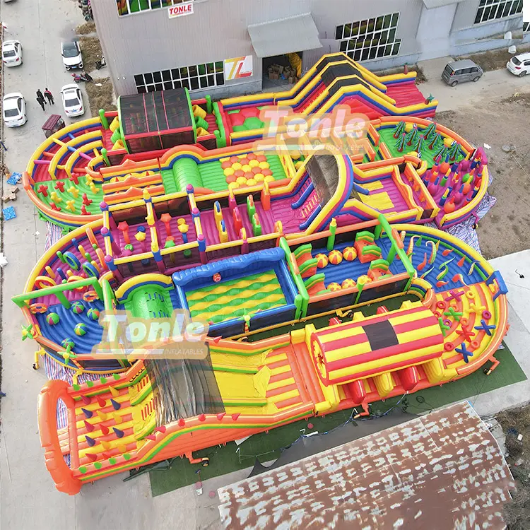 Aerial view of large multi-color Dinosaur World inflatable obstacle course with 12-person capacity