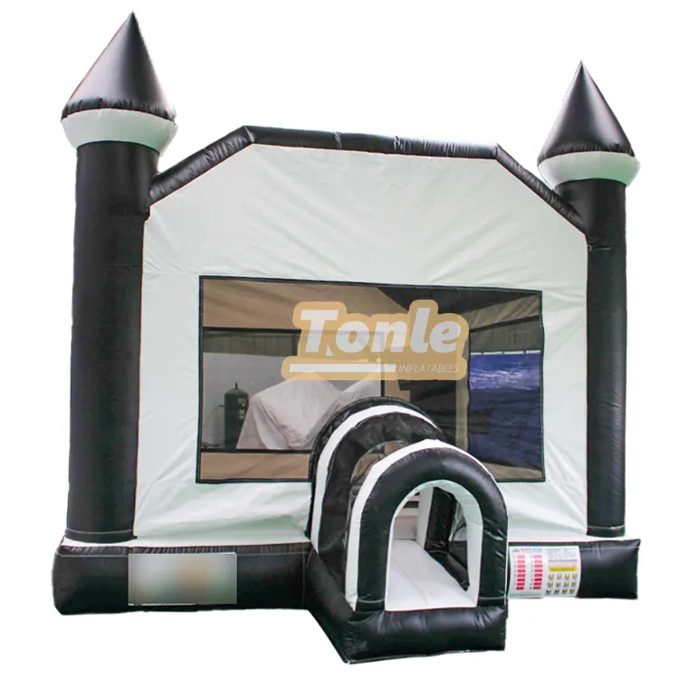 Front view of black and white inflatable bounce house with two turrets and arched entrance