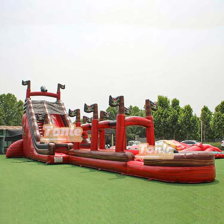 24ft pirate ship inflatable water slide with red hull and single lane on green grass
