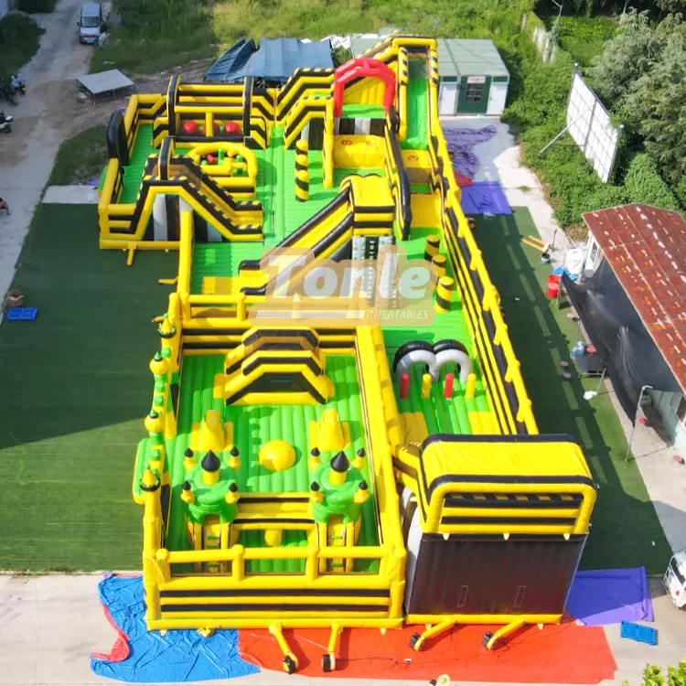 Aerial view of yellow green and black inflatable obstacle park with 15 person capacity