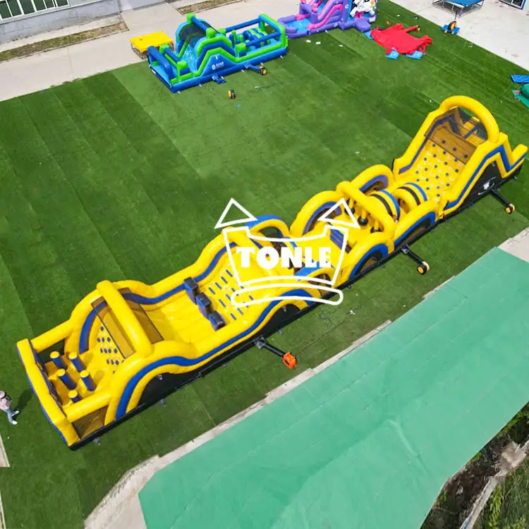 Aerial view of a 24.6m yellow and blue inflatable obstacle course on a green field