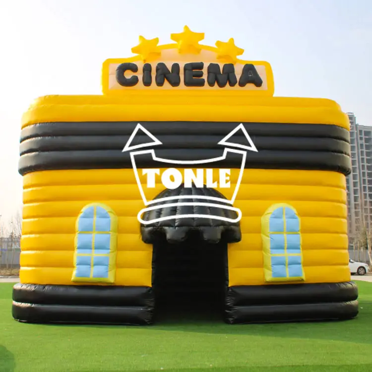 Yellow and black 8x6M inflatable cinema tent with 3D stars and blue windows on grass