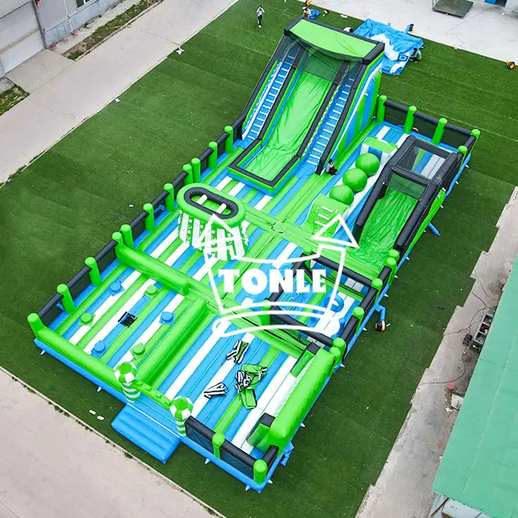 Aerial view of 23m green and blue inflatable fun city with dual slides and obstacle course