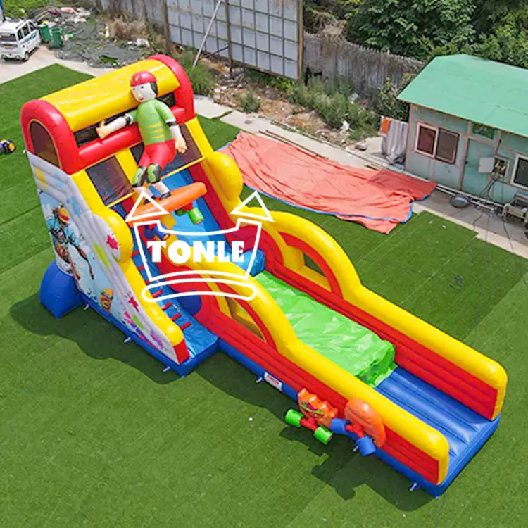 Red and yellow 11.6m inflatable dry slide with 3D character topper on green turf
