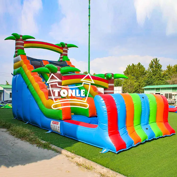 16ft rainbow single lane water slide with palm trees and blue splash pool on grass