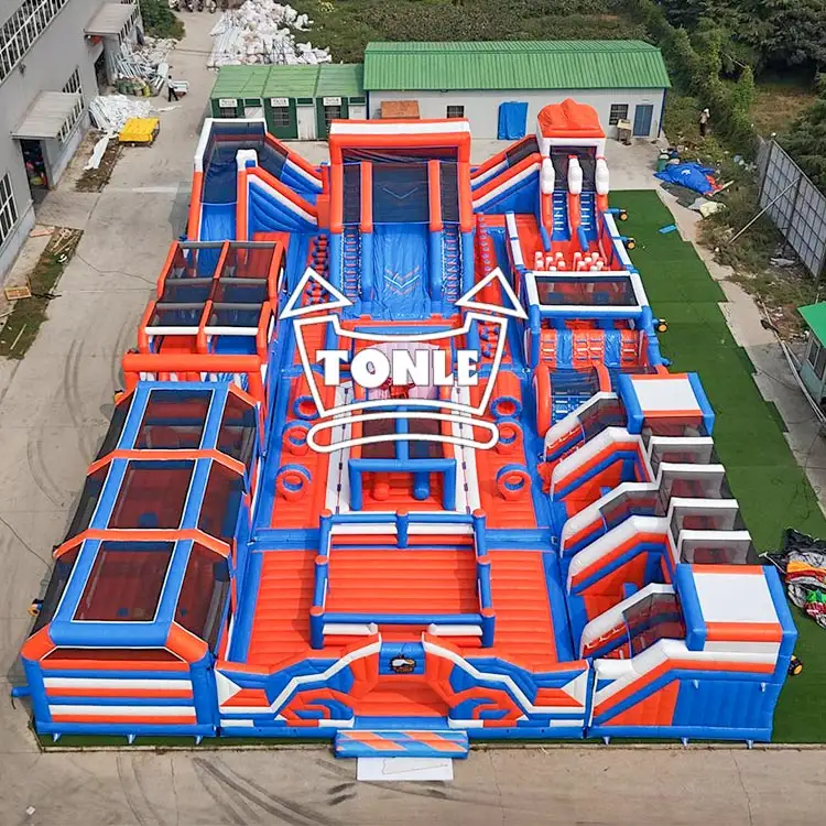 Aerial view of red blue and white 35x20M inflatable fun city with multiple slides and obstacles