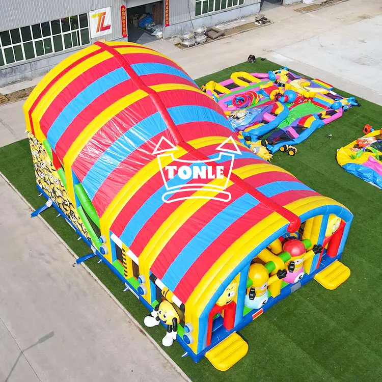 Aerial view of 13m Happy Minions inflatable amusement park with red yellow blue striped roof