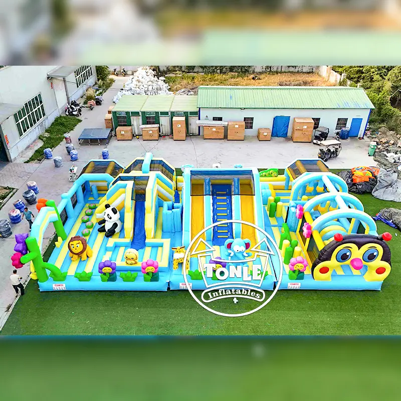 Aerial view of 18m Bee Zoo Theme Park inflatable with blue slides and animal figures
