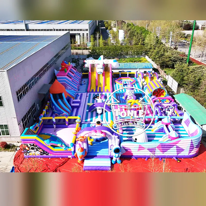 Aerial view of the 42m Dreamy Space Theme Park inflatable playground featuring purple and pink stripes, rocket slides, and astronaut decorations.