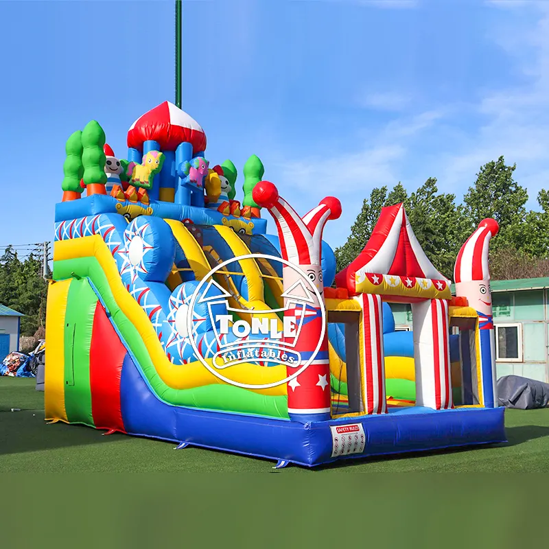 Circus-themed dual dry slide with red and white striped tents and clown pillars in blue, yellow, and green colors
